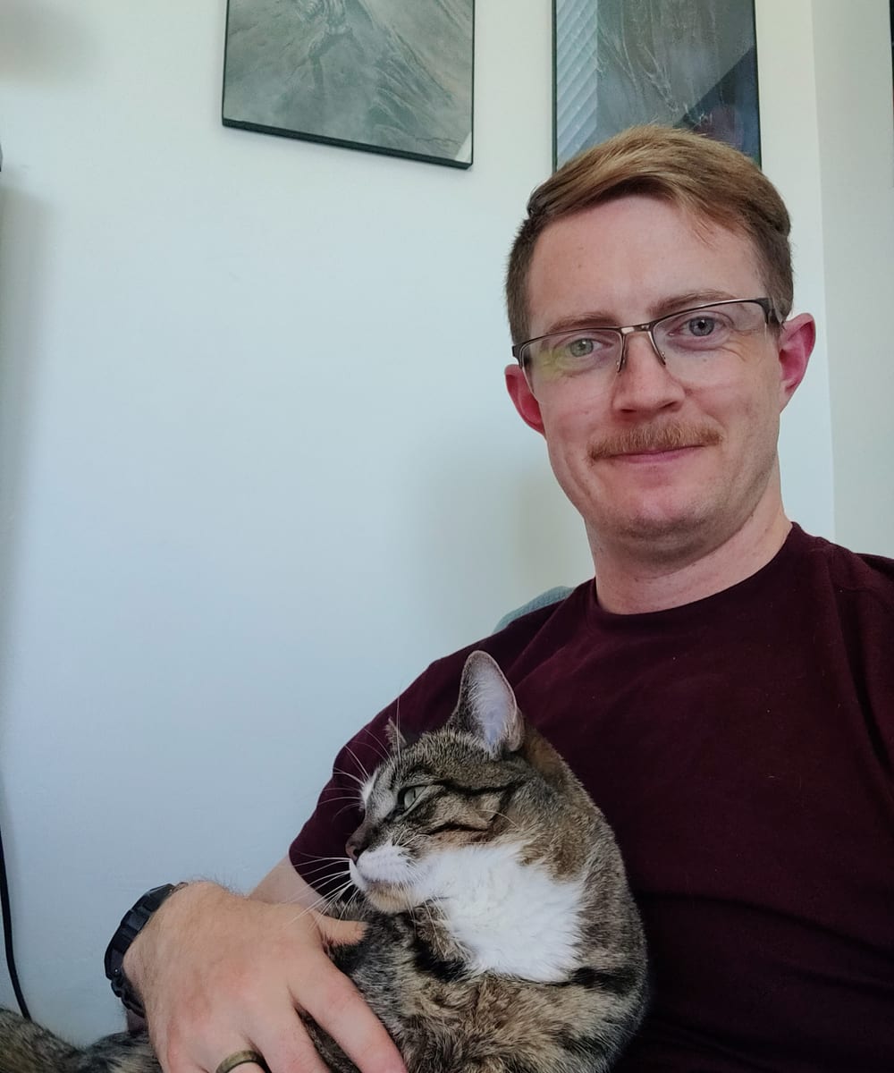 Jonathan Engle at home holding his cat